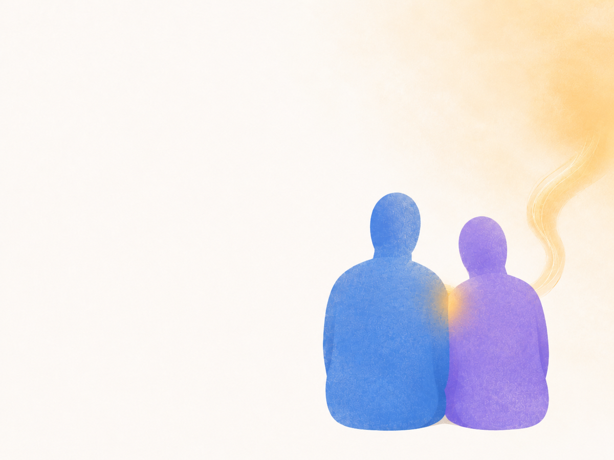 Two abstract figures sitting close together, with warm light passing between them